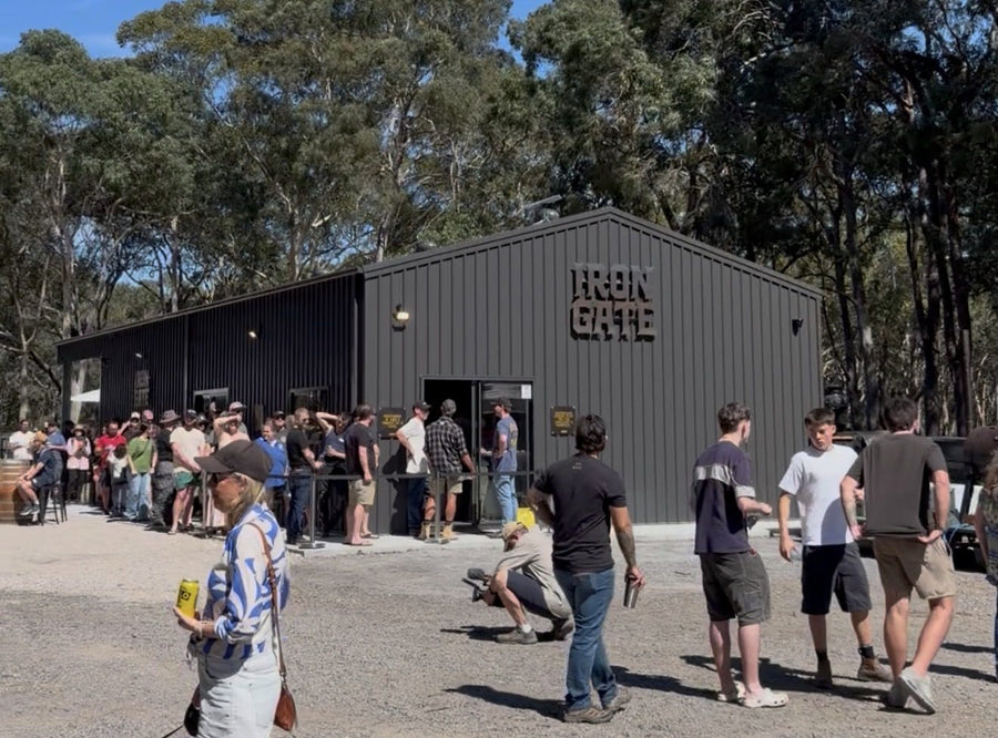 A crowd of customers gathered outside the black Iron Gate workshop in Anna Bay